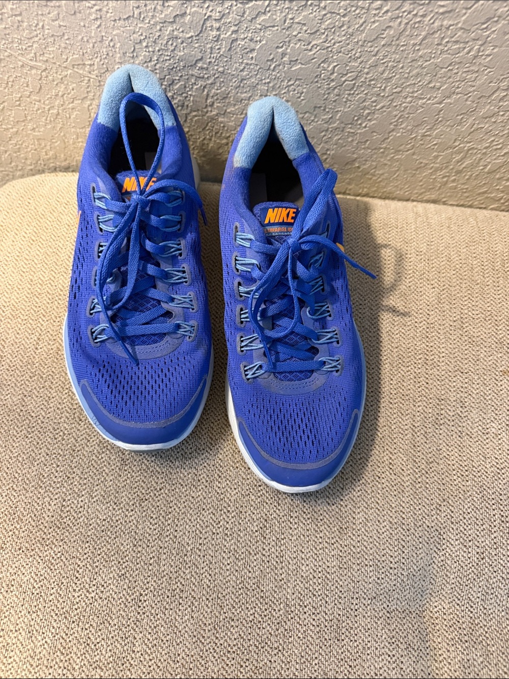 Nike Women's Royal Blue Athletic Running Shoes with Orange Logo